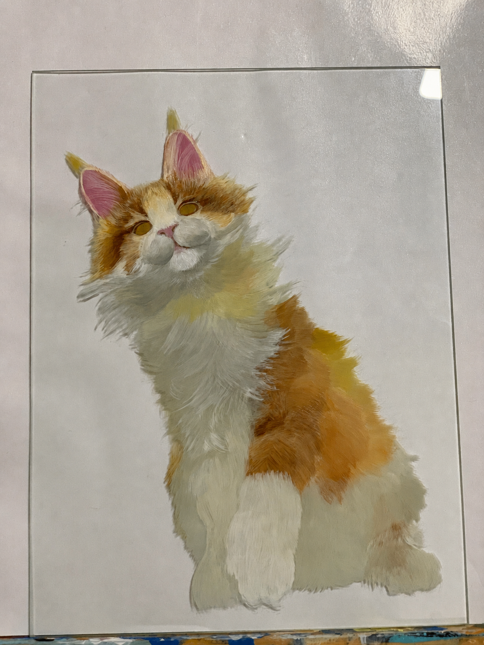 Unframed cat painting on glass before final presentation