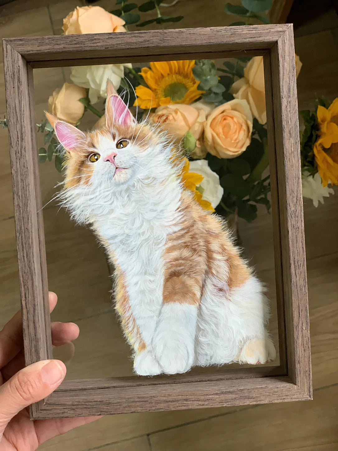 Finished orange-and-white cat glass painting held in a wood frame