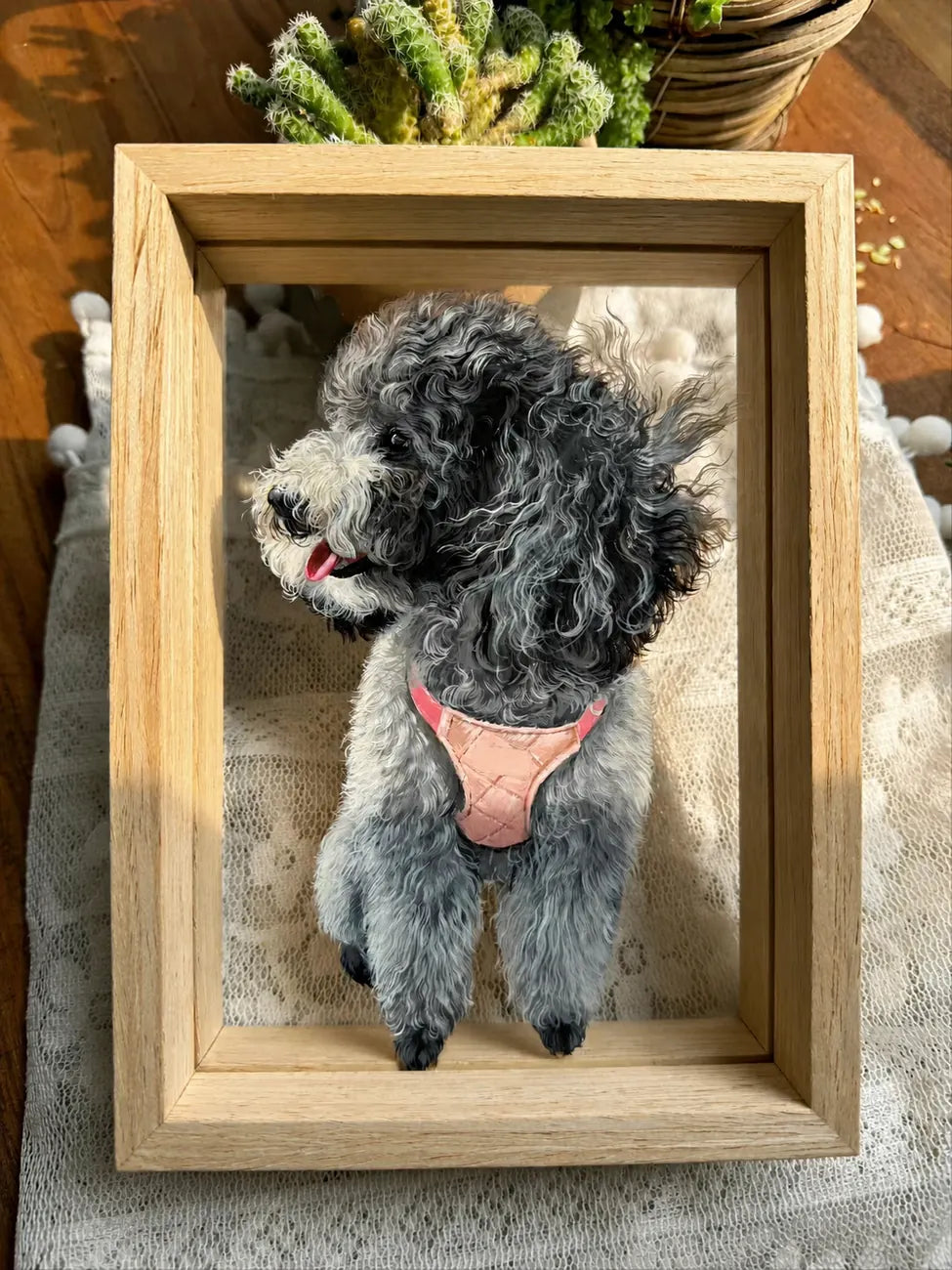 Finished black poodle glass portrait in a wood frame