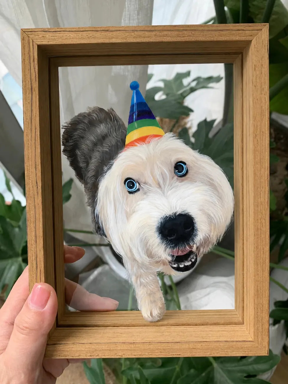 Finished party-hat dog glass portrait held by hand