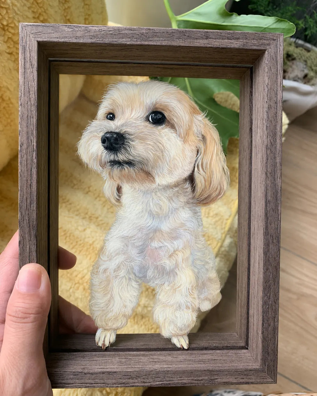 Finished cream dog glass portrait held in a dark frame